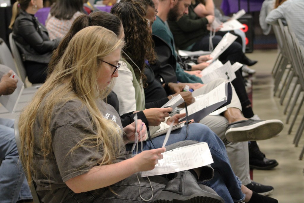 Participants in an event designed to simulate reentering society after incarceration attempt to get a new ID.