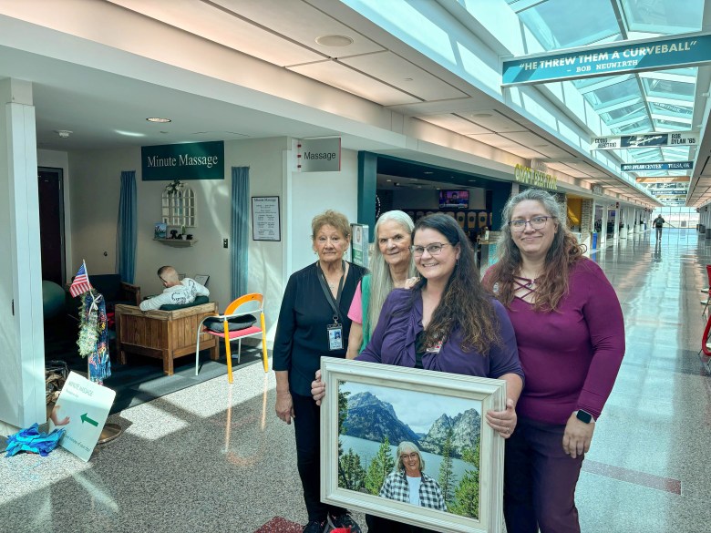 Left to right: Lana Wilson, Jeanie Renfrow, Dan'niel McKnight and Stacey Owens pose with a portrait of Helen Wormuth on Oct. 31, 2025.
