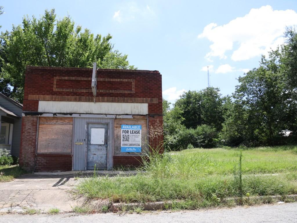 Photo of building with For Lease sign