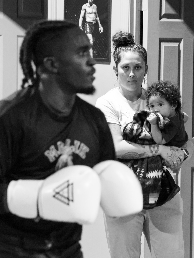 Photo of Malik Thompson, Syd Butcher, and their son Symba