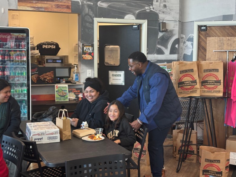 AJ Johnson, owner and CEO of Oasis Fresh Market, greets family attending free lunch service on Jan. 28, 2026.