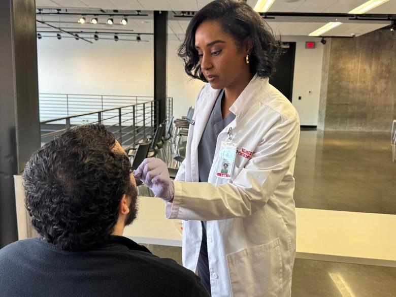 Meghan Scott, owner of Reliable DNA Testing Solutions, swabs a cheek to send off for paternity testing.