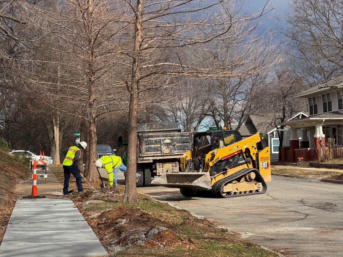 Construction crews work on sidewalk