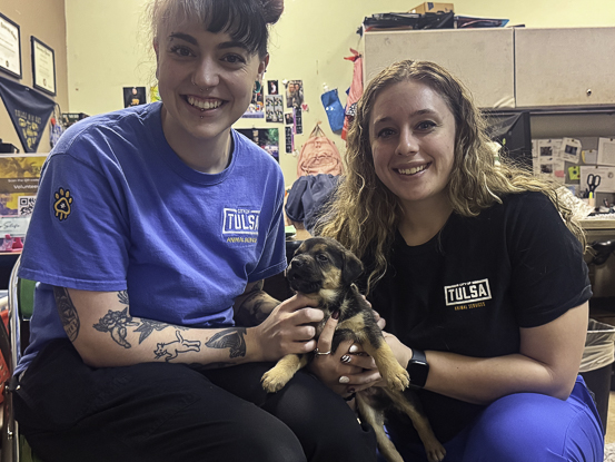 Veterinarian assistant Emma Lollis, left, and veterinarian clinic supervisor Taylor Roepke-Perez show off a rescued German Shepherd puppy