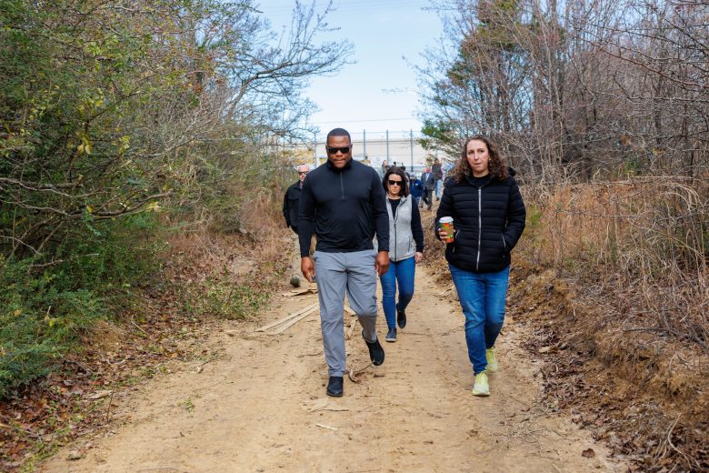 Mayor Monroe Nichols, Julie Davis, CEO of YWCA Tulsa and Emily Hall, Senior Adviser on Homelessness for the City of Tulsa, lead a press tour of a homeless encampment area located behind Lowes and Staples at 71st & US 169 on December 18, 2025 in Tulsa, Oklahoma.