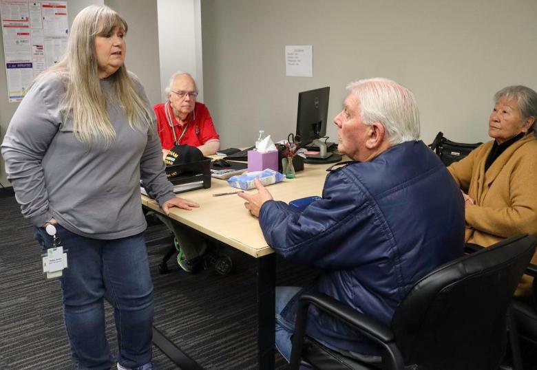 Kathy Jones, left, speaks with Ronald Trippe and Kwiran Lee Trippe about their tax return at LIFE Senior Services, Feb. 2, 2026. Jones oversees the program that provides free tax help for seniors who are at least 60 years old and making a total income of $69,000 or less.