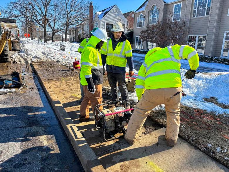 City of Tulsa maintenance crew dig up sinking sidewalk to address bursting pipe on E. 21st St. on Jan. 26, 2026.