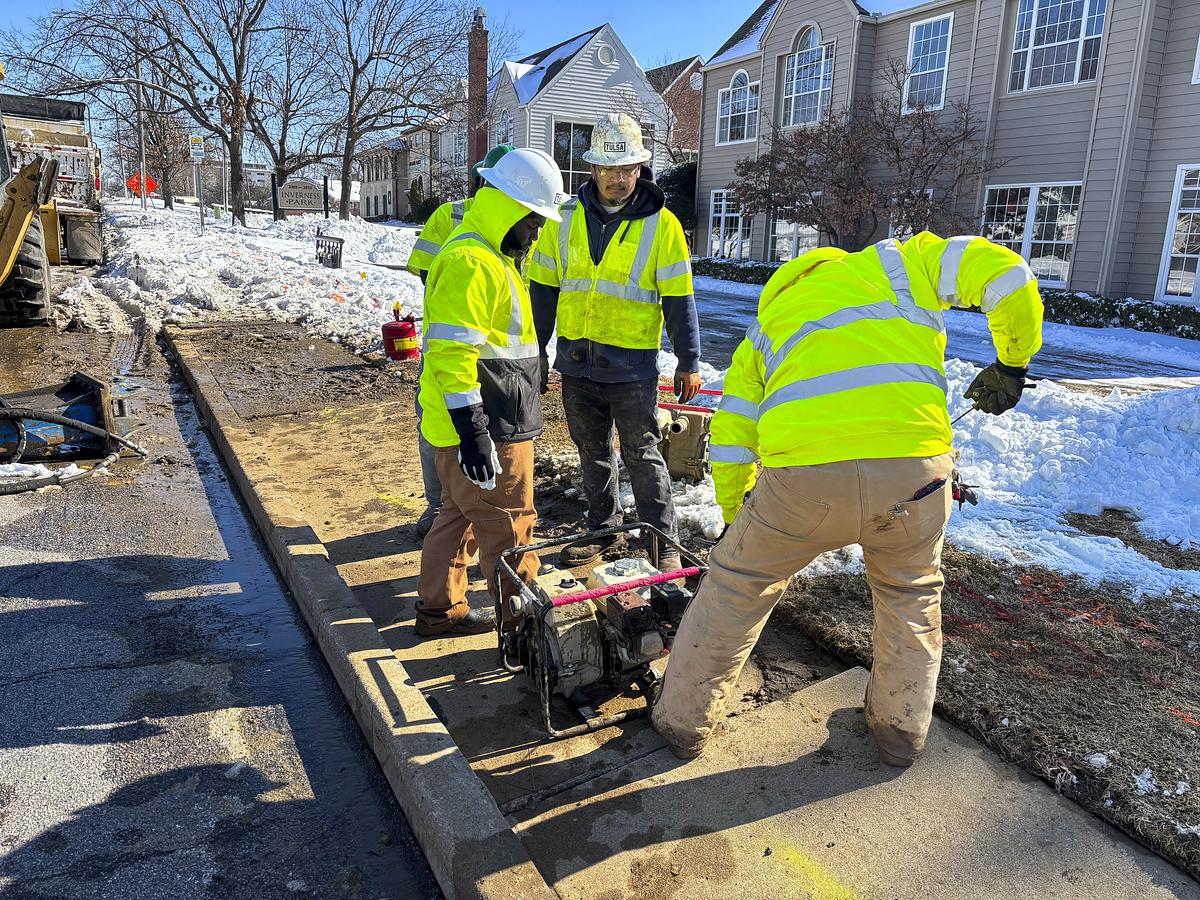 City of Tulsa maintenance crew dig up sinking sidewalk to address bursting pipe on E. 21st St. on Jan. 26, 2026.
