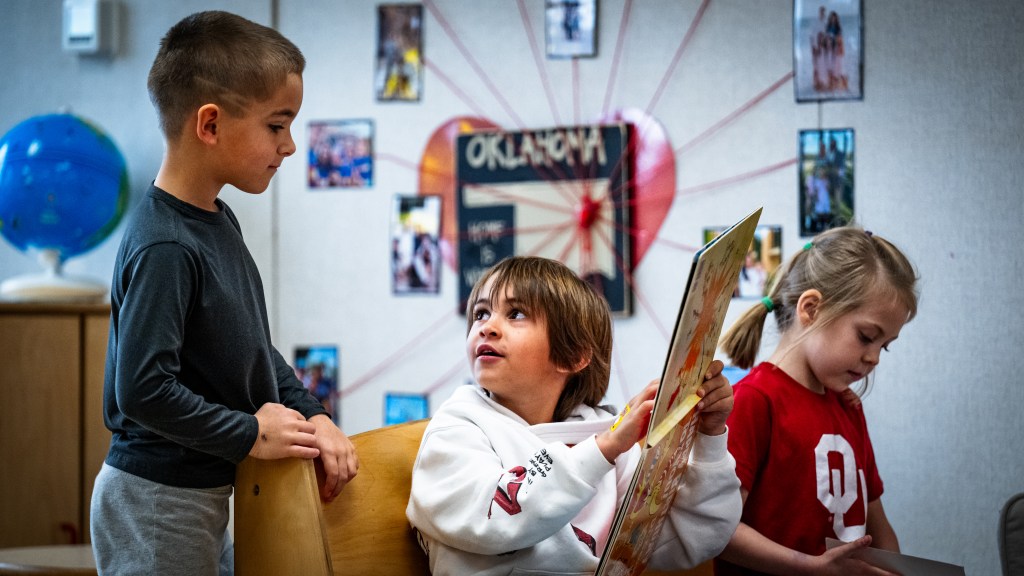 From left, Rush Pontree, Leo Porto and Irie Owens read a book together in kindergarden at Monte Casino on Wednesday, March 4, 2026.
