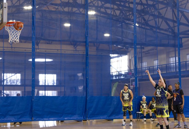 athletes compete in basketball game