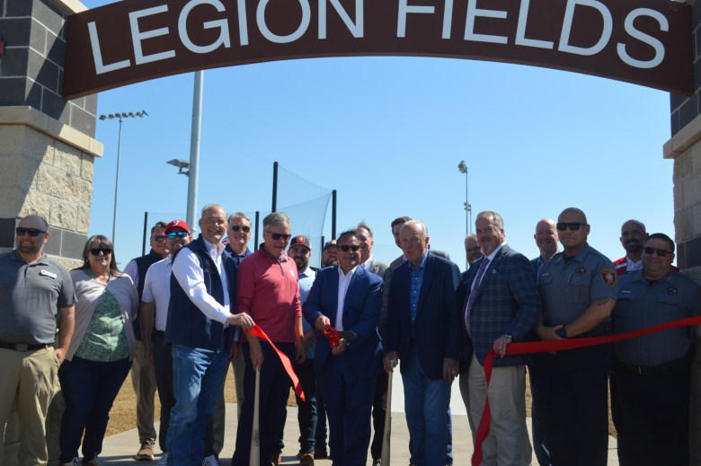 Tulsa County Commissioner Stan Sallee, center, cuts a ribbon at the March 25, 2026, unveiling of two newly-reconstructed baseball fields at O'Brien Park.