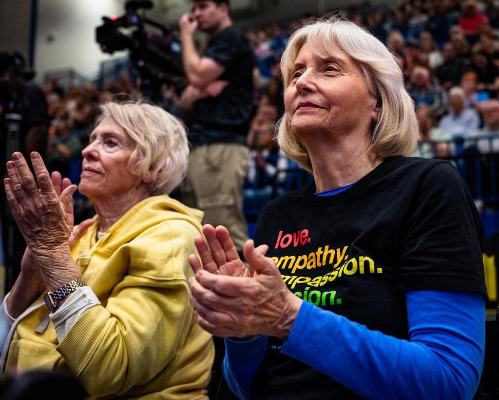 Ann Thompson, right, listens to former U.S. Secretary of Transportation Pete Buttigieg speak at Will Rogers High School on Saturday, April 18, 2026. 