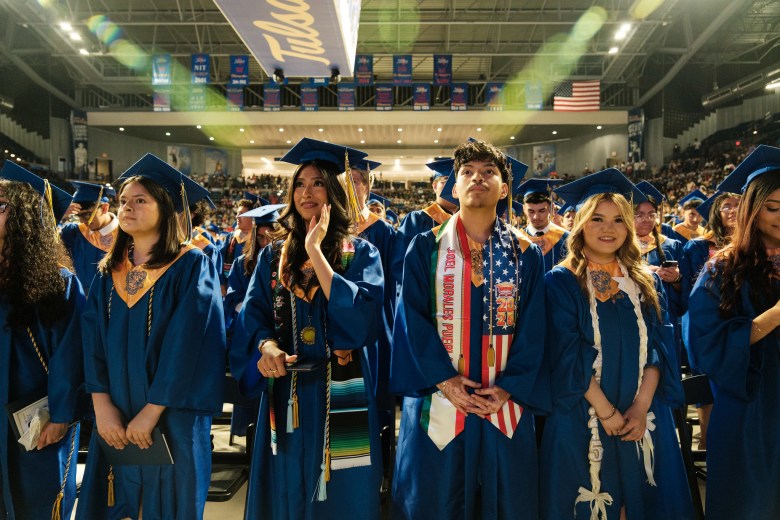Will Rogers High School students stand during the May 13, 2025, graduation ceremony.