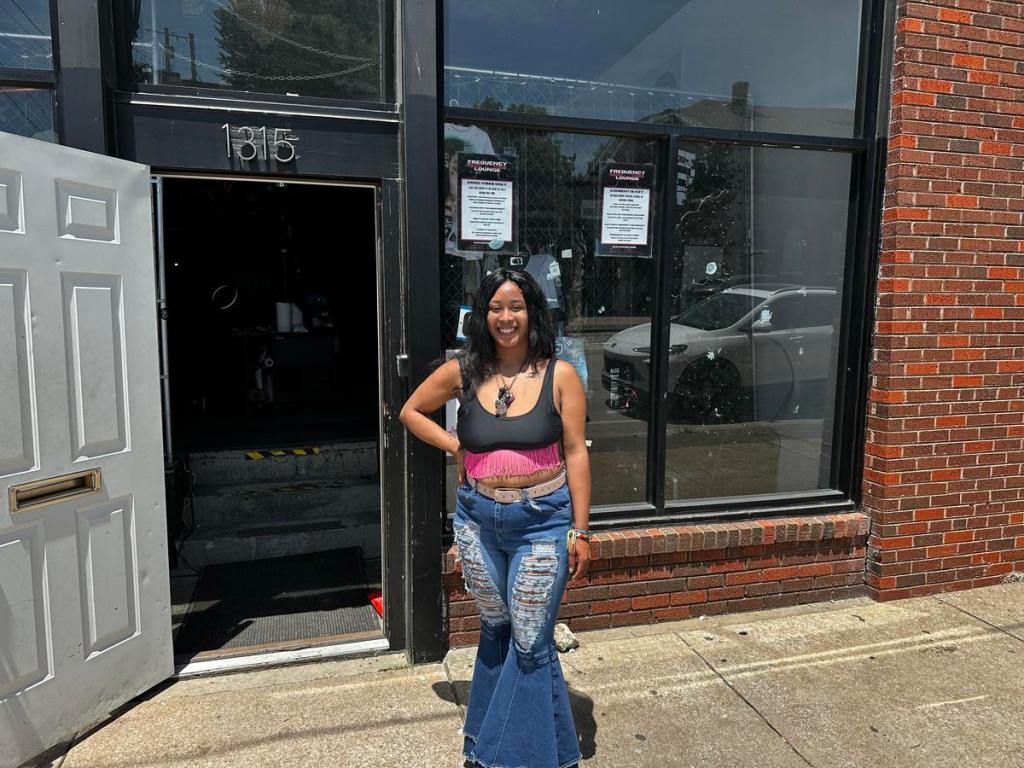 Nikole Dragon, co-owner of Frequency Lounge in Tulsa's Pearl District, stands outside the space during the Hidden Creatives tour on May 24, 2026. 