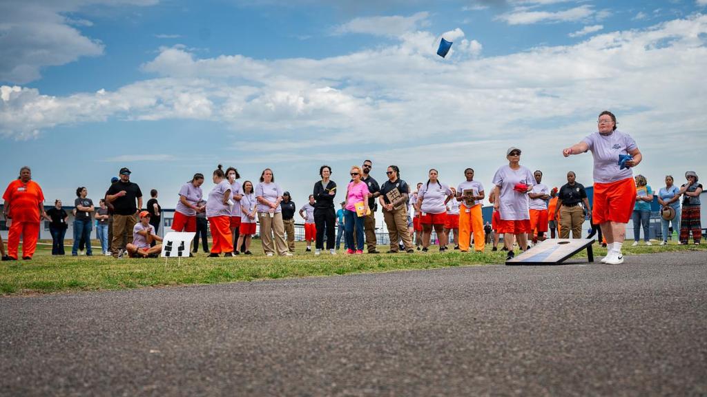 An inmate competes in corn hole during the first annual inmate games at Mabel Bassett Correctional Center on Friday, May 15, 2026. The games are meant to boost morale and encourage friendly competition. 