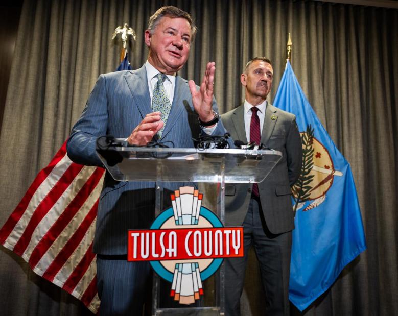 Attorney General Gentner Drummond, left, stands with Tulsa County District Attorney Steve Kunzweiler to announce charges against a former Tulsa Public Schools administrator and two others during a June 4, 2026, press conference. The trio is accused of stealing around $780,000 from Tulsa Public Schools.
