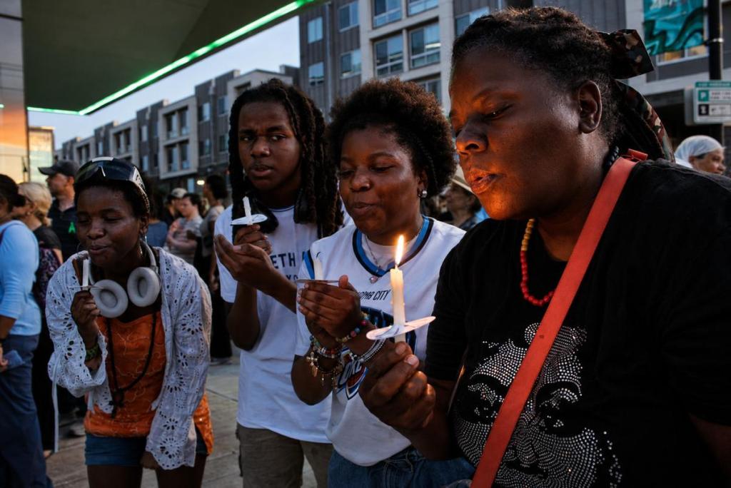 People gather during the Black Wall Street candlelight vigil at Greenwood Rising May 31, 2026.