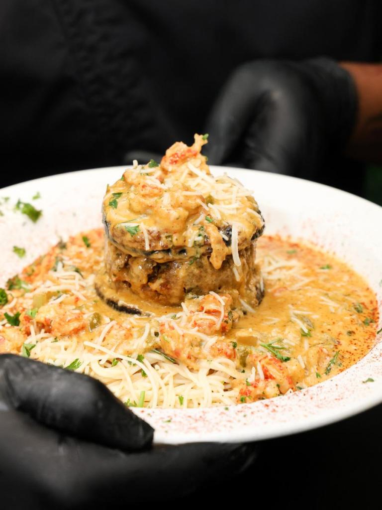 C’est Bon Kitchen & Libations' menu includes The Anderson. The dish is comprised of crispy fried eggplant, stuffed with crabmeat and crawfish au gratin, crowned with a parmesan creamy butter drizzle atop a bed of angel hair pasta.