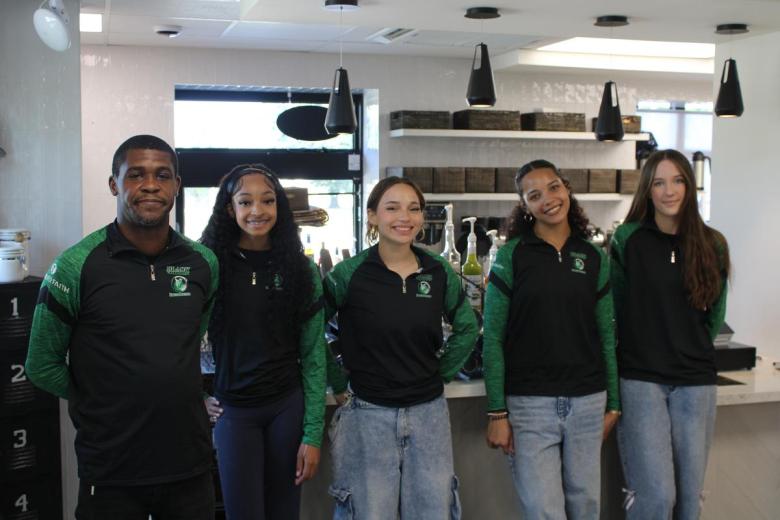 Employees at Black Wall Street Liquid Lounge. Most of the staff are in high school, or in their teenage years.