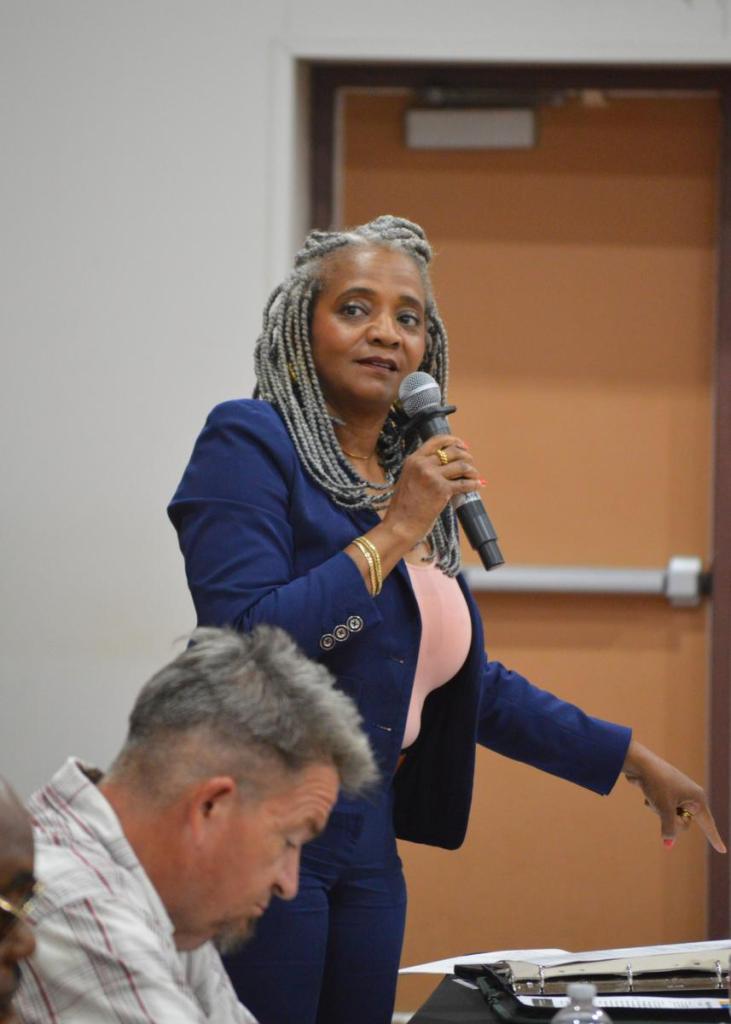 District 1 City Councilwoman Vanessa Hall-Harper points toward a copy of the latest Equality Indicators report during a candidate forum on July 22, 2026. “Justice is the only indicator that we have failed consistently every year on,” the councilwoman said.