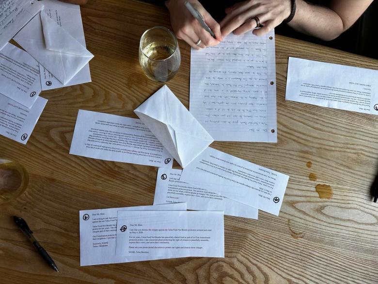 More than 30 people gathered at Heirloom Rustic Ales July 14, 2026, to write letters to city officials asking for charges against Tulsa Food Not Bombs to be dropped.