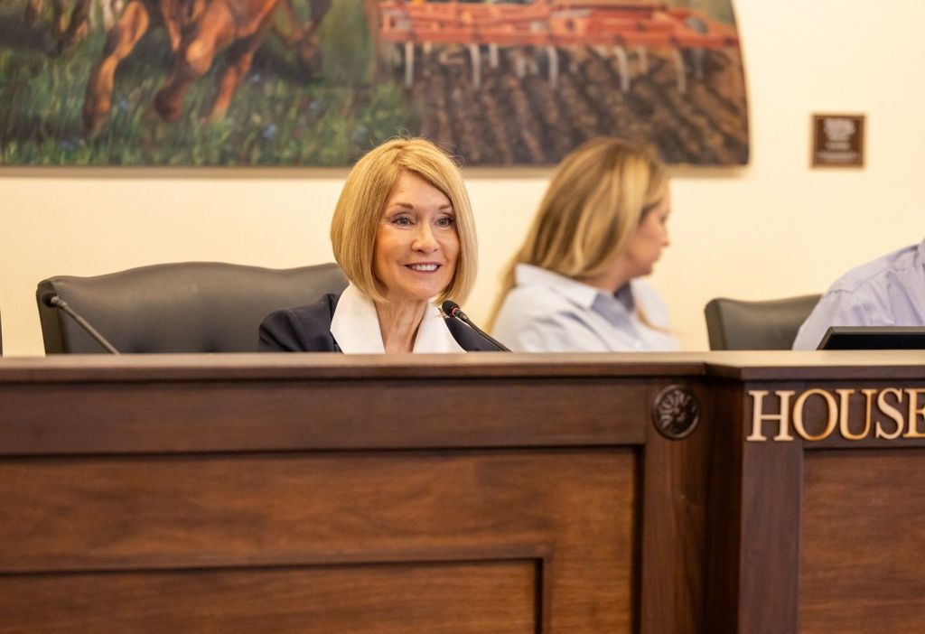 Tammy West smiling behind desk